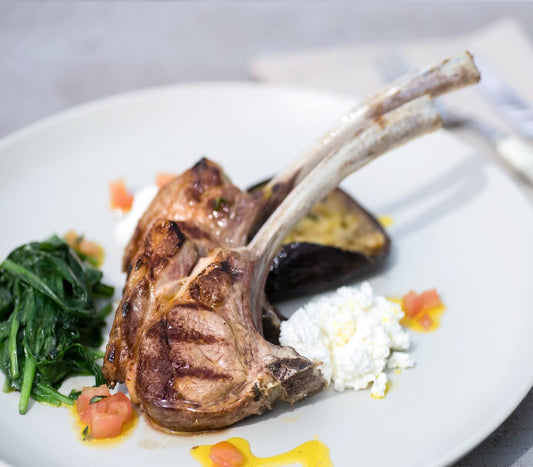 Charred Lamb Tomahawk with Garlic, Goats Curd & Baked Eggplant